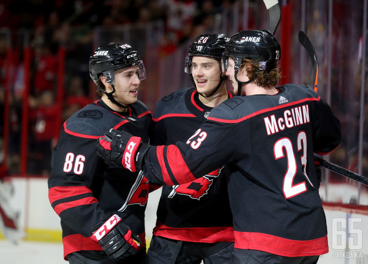 RALEIGH, NC - JANUARY 13:  Sebastian Aho #20 of the Carolina Hurricanes celebrates with teammates Teuvo Teravainen #86 and Brock McGinn #23 after scoring a goal during an NHL game against the Nashville Predators on January 13 ,2019 at PNC Arena in Raleigh