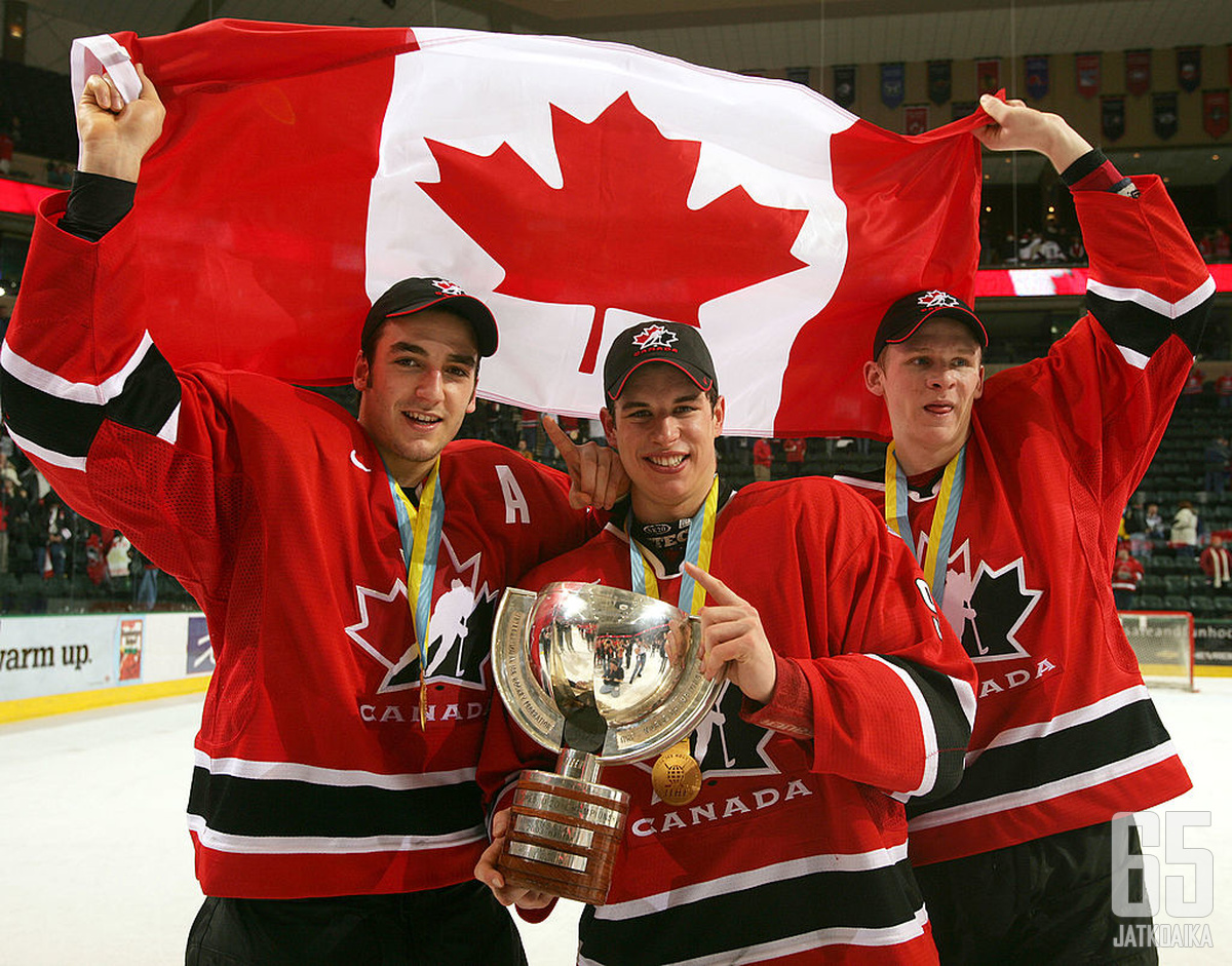 GRAND FORKS, ND - JANUARY 4:  Corey Perry #24, Sidney Crosby #9 and Patrice Begeron #37 hold the World Junior Championship trophy after Canada won the gold medal game 6-1 over Russia at the World Junior Hockey Championships on January 4, 2005 at the Ralph