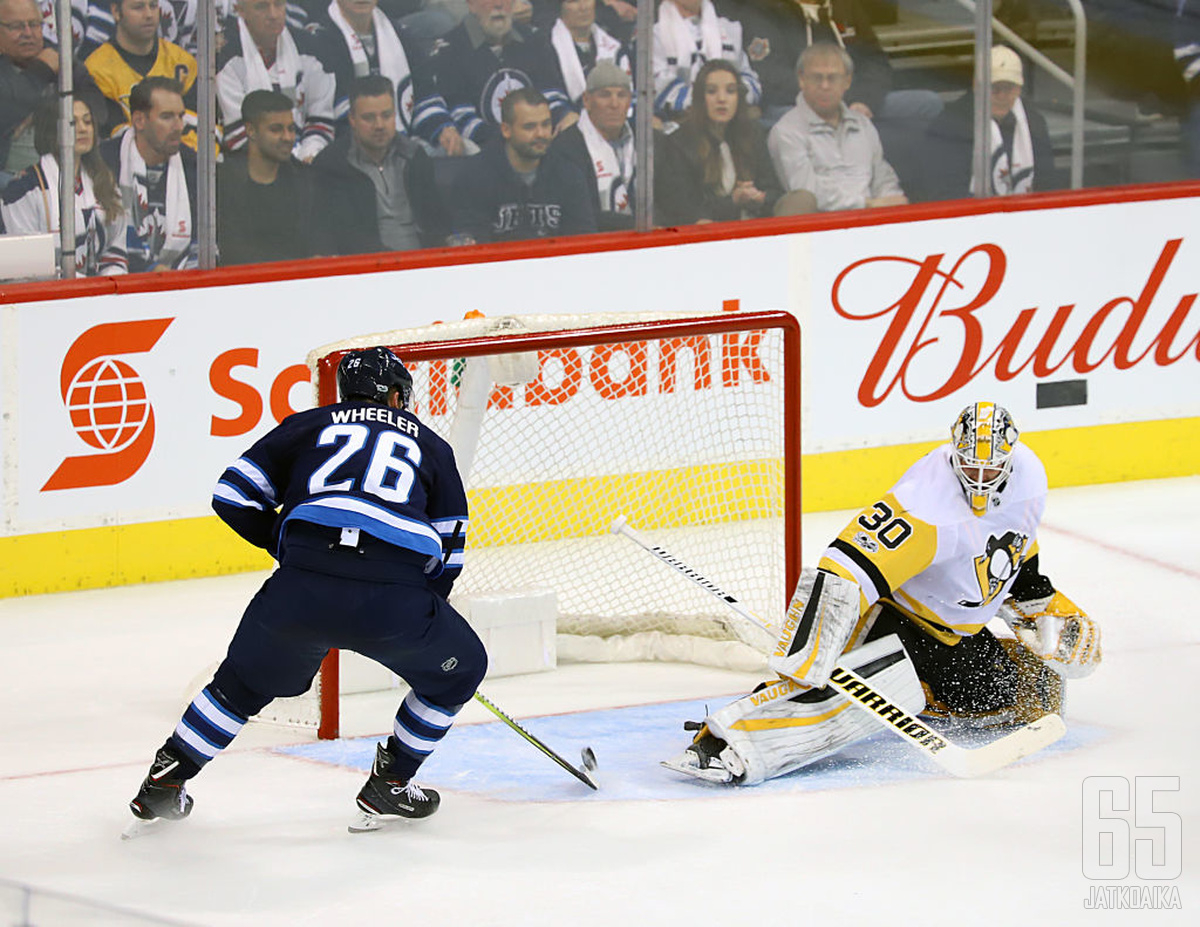 Blake Wheeler ohjaamassa kiekkoa Matt Murrayn selän taakse.